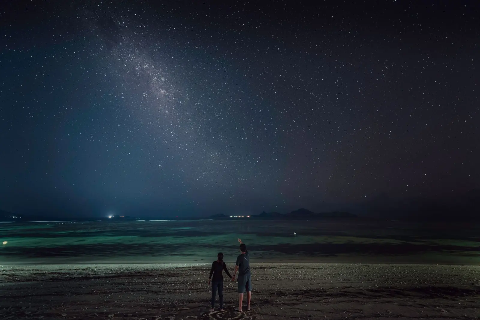 Two people under a starry night sky