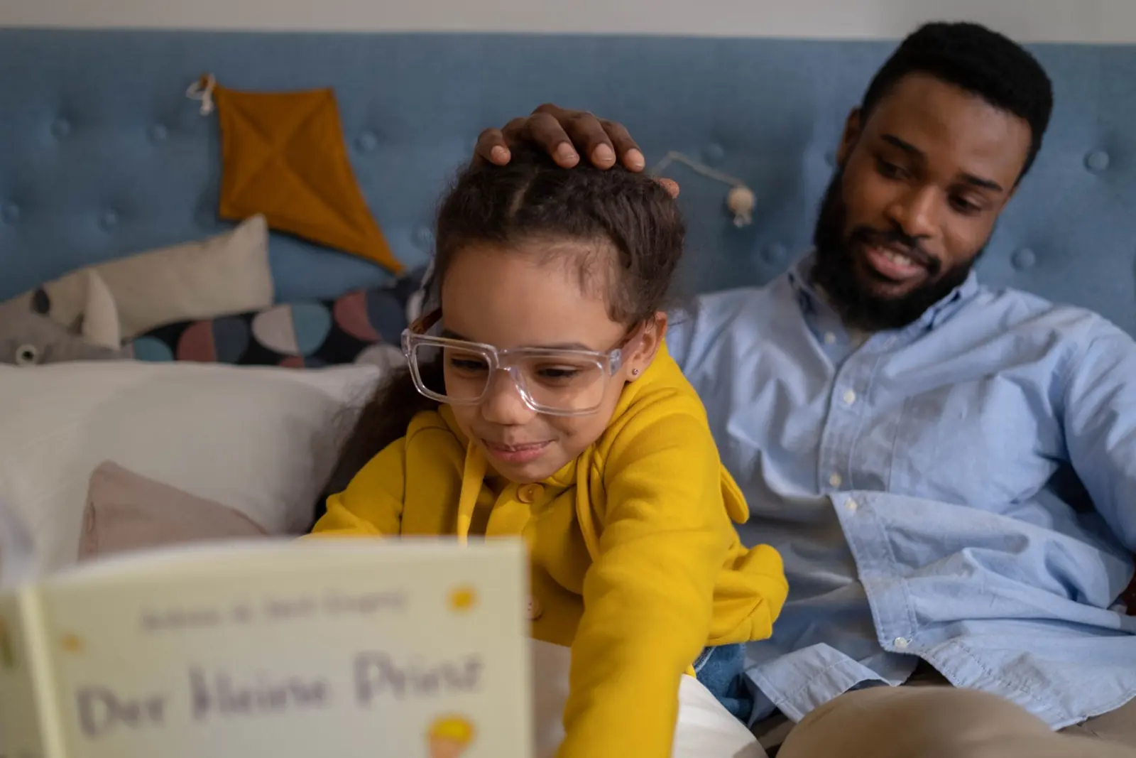A father and daughter reading a book together